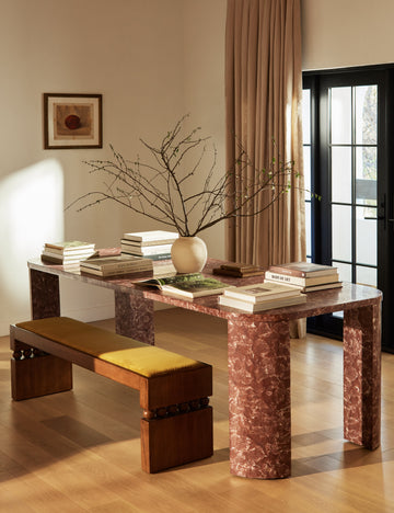 #color::espresso | Ceiba mixed-material sculptural accent bench by Carly Cushnie styled with a rose marble dining table.