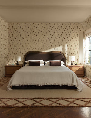 A bedroom design featuring the Clairmont Handwoven Lattice Border Jute Rug by Jake Arnold.