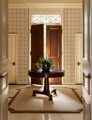 A foyer featuring the Caraby grid pattern Wallpaper by Jake Arnold