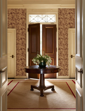An entryway featuring the Dors Grasscloth Wallpaper by Jake Arnold on the walls.