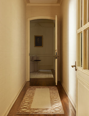 A hallway featuring the Clairmont Handwoven Lattice Border Jute Rug by Jake Arnold in the runner size