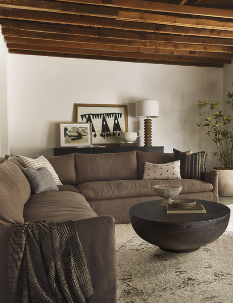 #color::mushroom #configuration::left-facing | The Portola Mushroom brown linen Slipcover corner sectional Sofa sits atop a plush ivory rug next to a woven chair