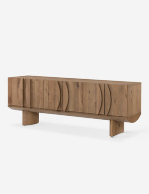 Angled view of the Remwald sculptural oak wood low profile media console.