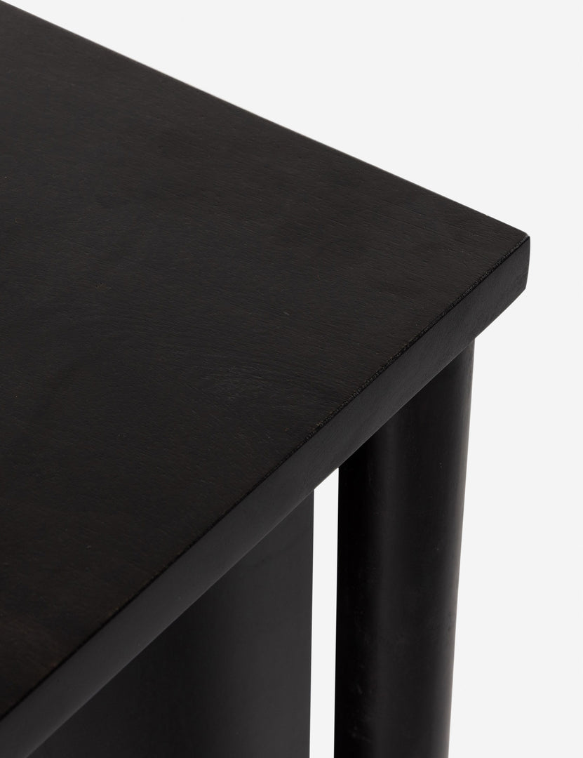 #color::black | Corner of the Isaura black cane-paneled sideboard cabinet.