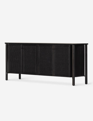 Angled view of the Isaura black cane-paneled sideboard cabinet.