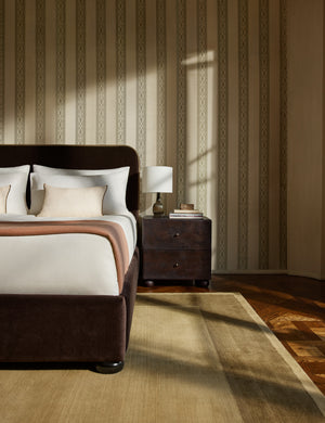 A bedroom featuring the Deller Hand-Loomed Wool Rug by Jake Arnold