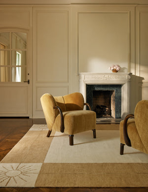 Two accent chairs styled with the Stansby Hand-Knotted Starburst Wool Rug by Jake Arnold