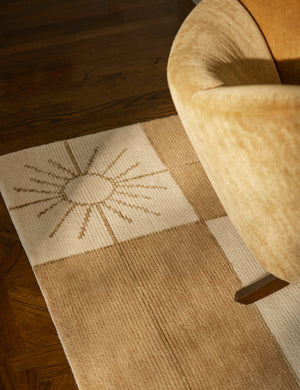 Close up of the Stansby Hand-Knotted Starburst Wool Rug by Jake Arnold under an accent chair