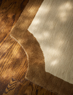 Close up view of the scalloped corner of the Clapham Hand-Loomed Wool Rug by Jake Arnold.