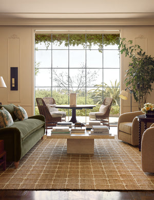 A living room featuring the Beddow Flatweave Jute Grid Rug by Jake Arnold