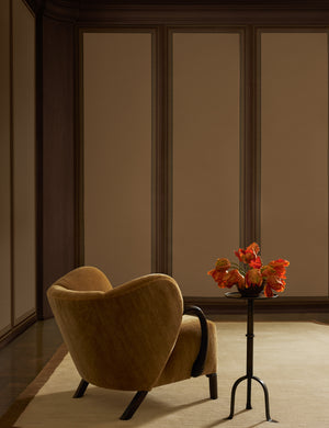 An accent chair and drink table sit in a room featuring the Lansbury Grasscloth Wallpaper Mural by Jake Arnold on the walls