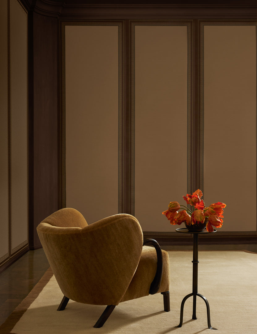 #color::maroon | An accent chair and drink table sit in a room featuring the Lansbury Grasscloth Wallpaper Mural by Jake Arnold on the walls