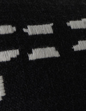 Close up view of the pattern of the Accord Black Linen Lumbar Pillow by Elan Byrd.