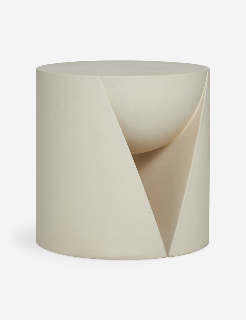 #color::ivory | Angled view of the Amaya round sculptural cement side table.