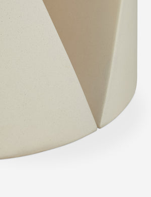 Close up of the base of the Amaya round sculptural cement side table.