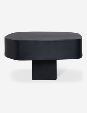 Side profile of the Armas black monolithic round outdoor coffee table by Sarah Sherman Samuel.