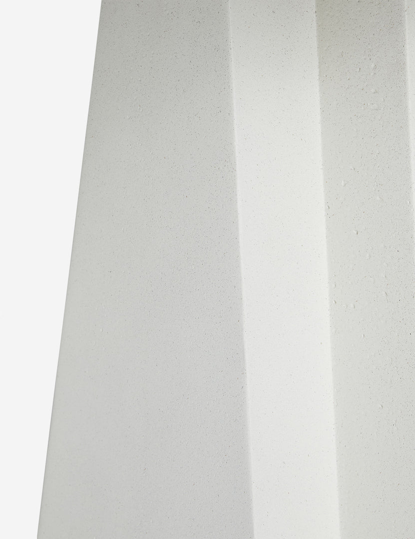 #color::textured-white | Close up of the base of the Avila modern round pedestal dining table.