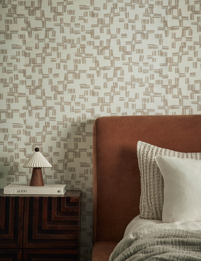 #color::ivory | Crossmarks Grasscloth Wallpaper by Élan Byrd styled on a bedroom wall behind the headboard.