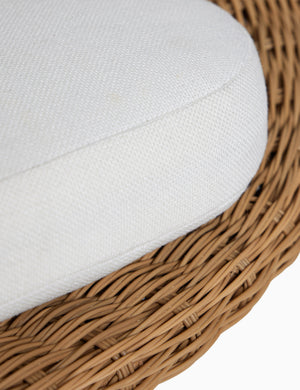 Close up of the seat cushion of the Ferran sculptural wicker outdoor accent chair.