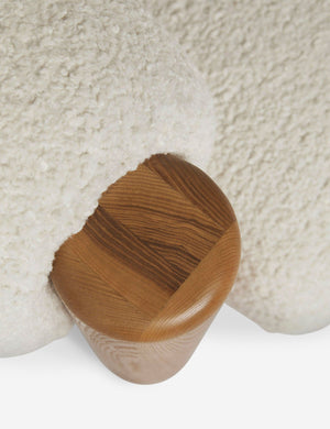 Bird's-eye view of the wooden leg on the top of the James faux sherpa accent chair