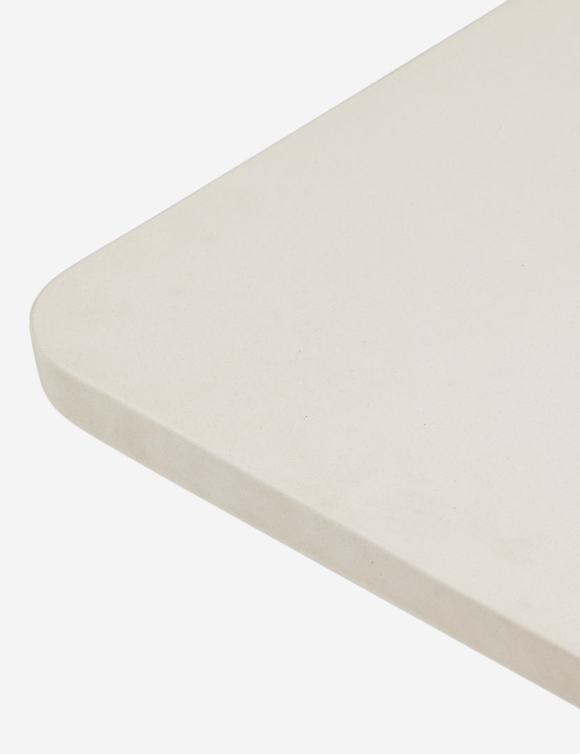 #color::ivory-and-terracotta | Corner of the top of the Keating sculptural two-toned outdoor dining table.