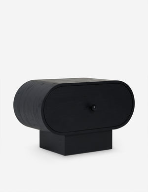 Angled view of the Laughlin retro pill shaped nightstand in black