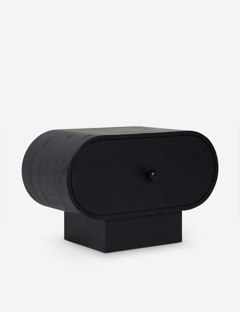 #color::black | Angled view of the Laughlin retro pill shaped nightstand in black