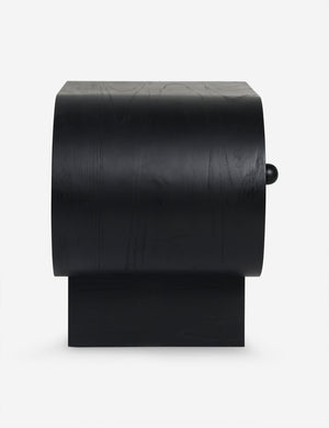 Side view of the Laughlin retro pill shaped nightstand in black