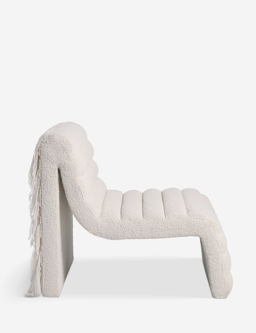 #color::ivory-boucle | Side profile of the Leon textural boucle channel tufted armless accent chair by Carly Cushnie.