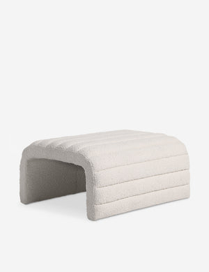 Angled view of the Leon textural boucle channel tufted waterfall ottoman by Carly Cushnie.