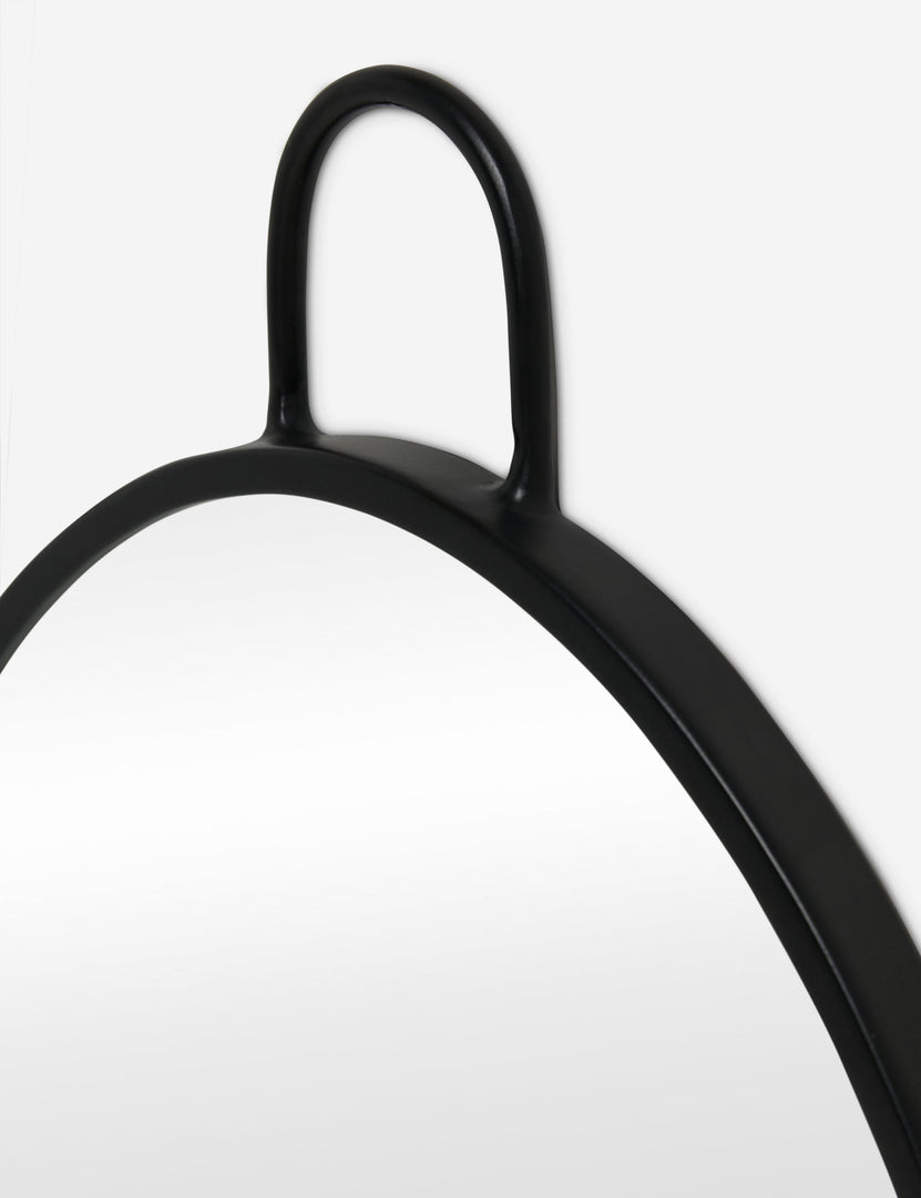 #color::black | Close up view of the Loop hanging oval wall mirror