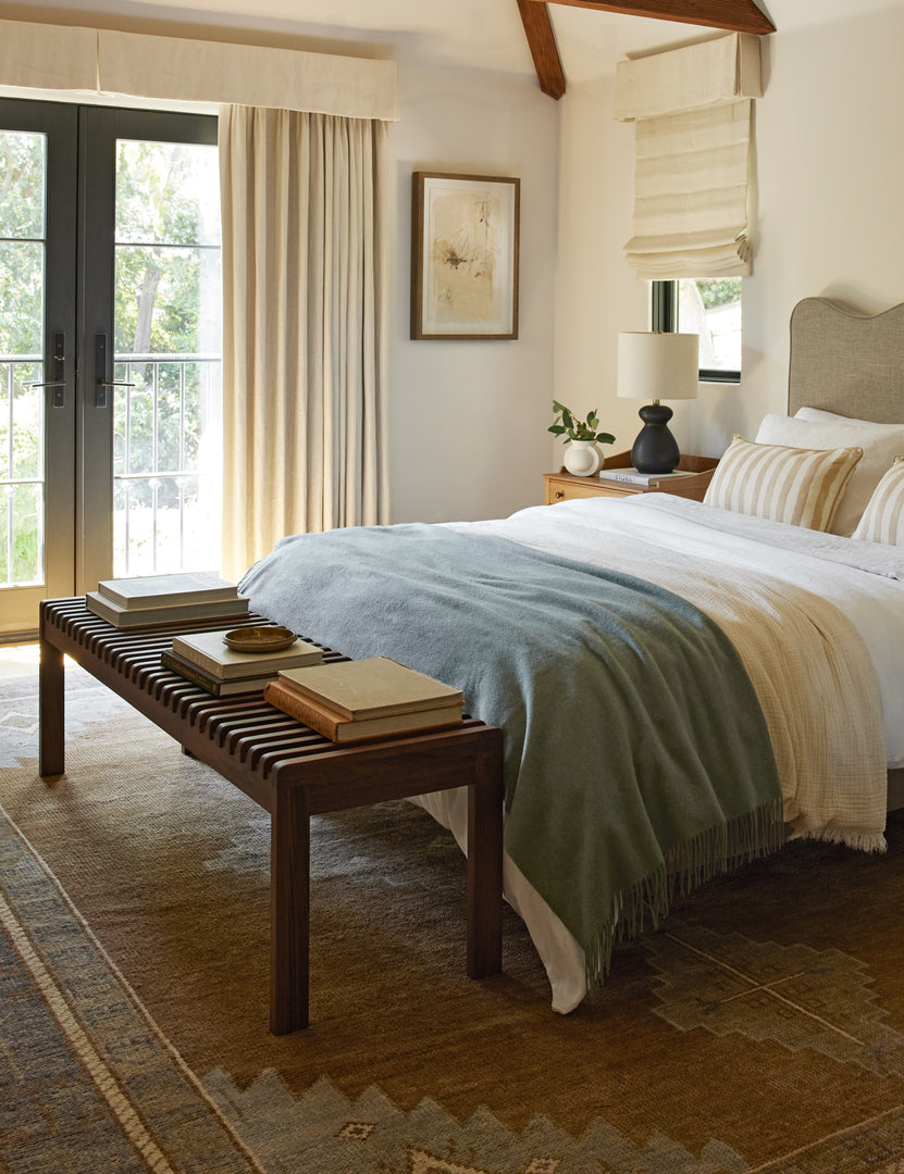 #color::walnut | Olson mid-century slatted wood bench in walnut styled at the foot of a bed.