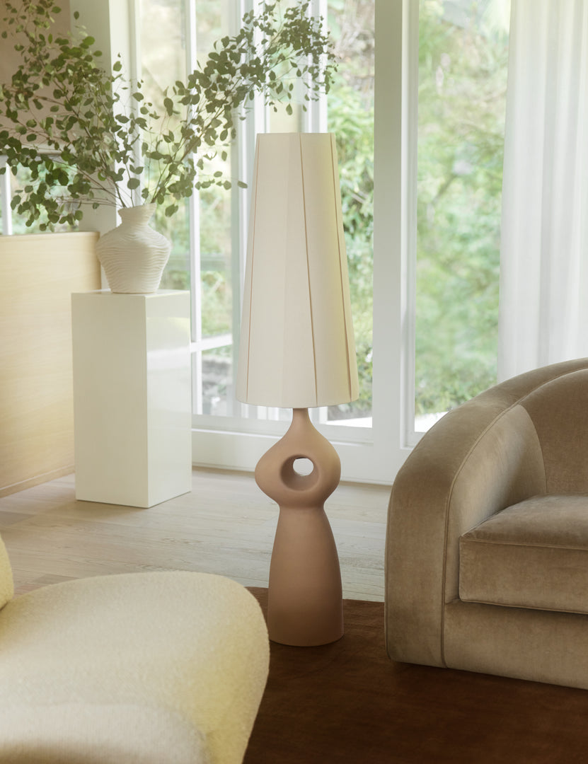 #color::rose | Rhodes sculptural ceramic floor lamp styled next to a sofa.