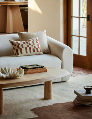 Accord Natural Linen Square Pillow by Elan Byrd styled on a sofa.