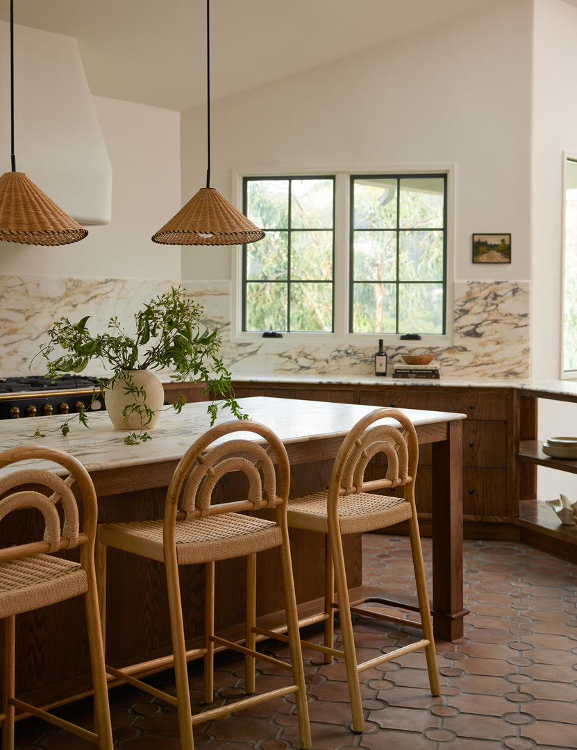 #color::natural #size::17-dia | Two Terrene Woven Rattan Pendant by Elan Byrd hanging above a kitchen island.