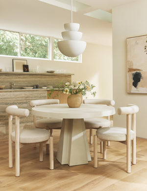 Dining room featuring the Avila modern round pedestal dining table.