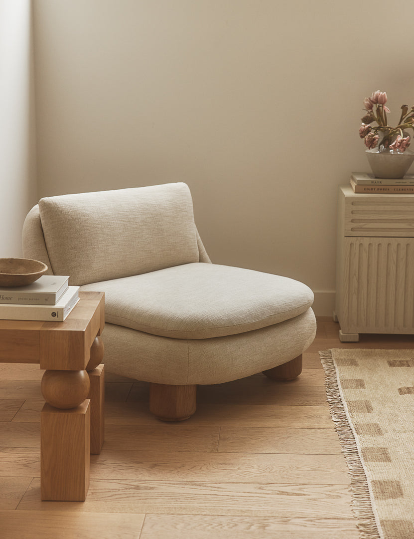 #color::ivory | Lozano chunky low-profile armless accent chair styled in the corner of a bedroom.