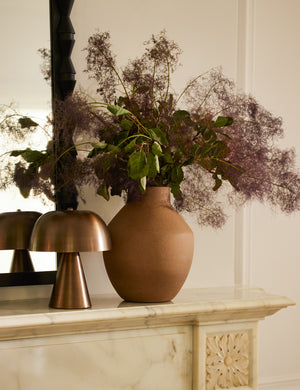  Monochromatic Wembley Cordless Mini Table Lamp styled on a mantel next to a vase