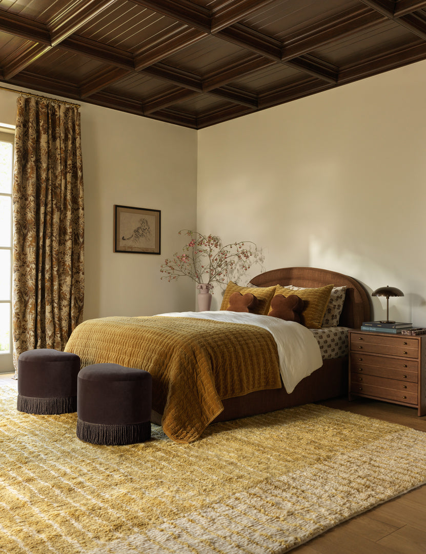 #color::ochre #size::6--x-9- #size::8--x-10- #size::9--x-12- #size::10--x-14- #size::12--x-15- | A bedroom featuring the Bhari thick organic design hand-knotted wool rug.