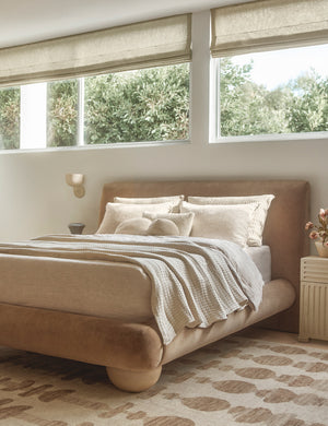 Talley modern sculptural wall sconce hung above a nightstand in a bedroom.