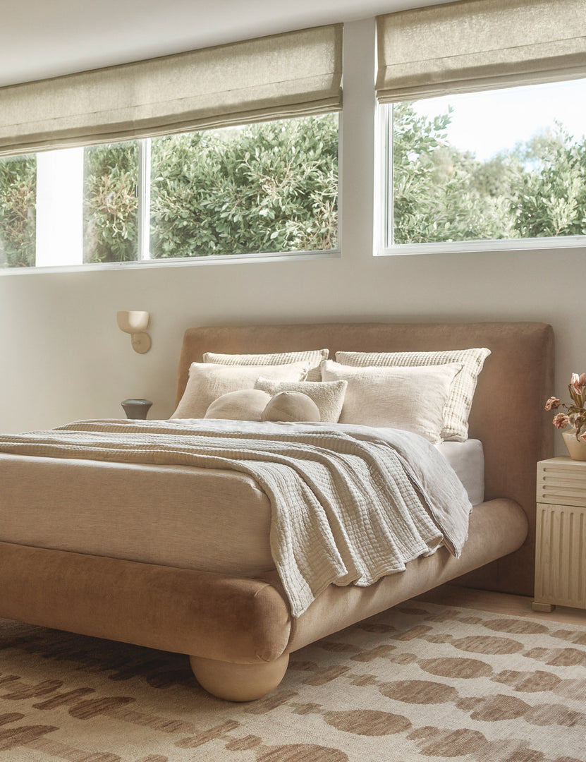 #color::sand | Talley modern sculptural wall sconce hung above a nightstand in a bedroom.