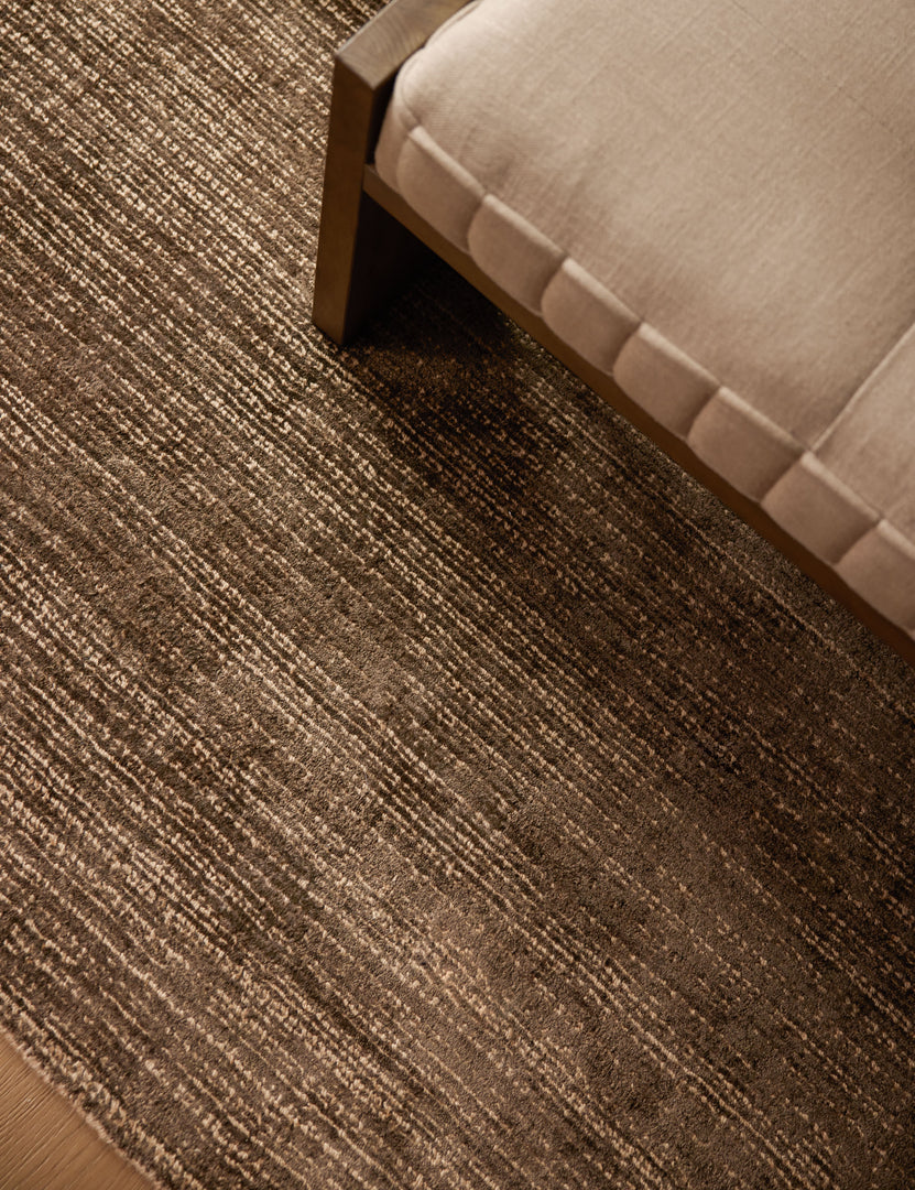 #color::chocolate #size::4--x-6- #size::5--x-8- #size::6--x-9- #size::8--x-10- #size::9--x-12- #size::10--x-14- #size::12--x-15- | The Danka high-contrast motif hand-loomed viscose-jute blend rug under a bench.
