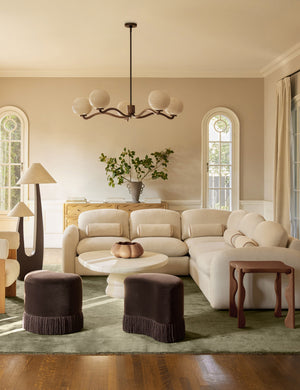 A living room featuring the Hannu modern round fibercement coffee table by Aimee Song