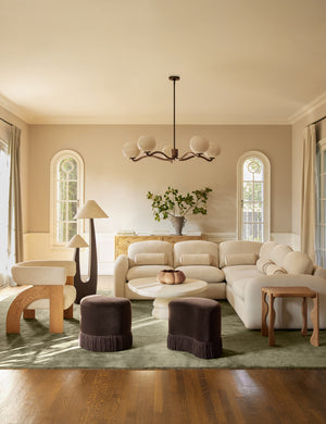 A living room featuring the Sutton Solid Color Hand-Loomed Viscose Rug by Aimee Song