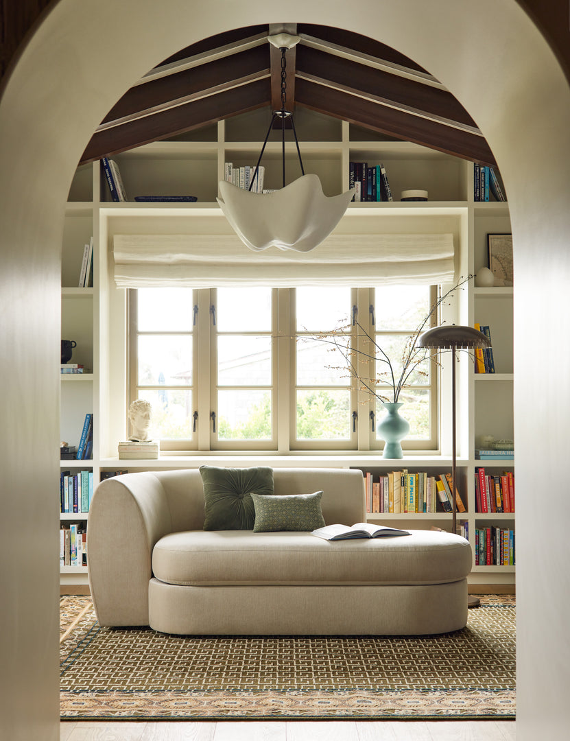 #color::ochre #size::2--x-3- #size::2-6--x-8--runner #size::3--x-5- #size::4--x-6- #size::5--x-8- #size::6--x-9- #size::8--x-10- #size::9--x-12- #size::10--x-14- #size::12--x-15- | A chaise sitting a top the Manca traditional geometric motif hand-knotted wool rug.