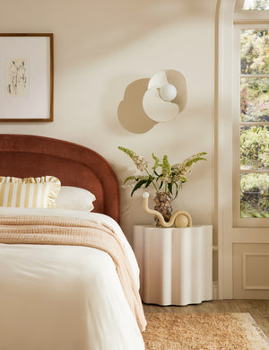 Soft Petal matte white floral silhouette wall sconce light styled above a bedside table