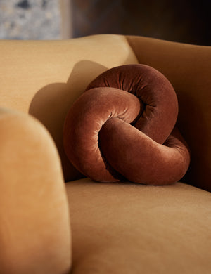 The Dewey velvet knot ball pillow styled on an accent chair.