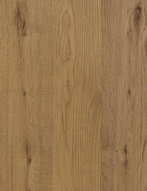 The wood grain of the Hermoza sculptural round pedestal extendable dining table.