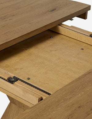 Close up of the extendable mechanisms of the Hermoza sculptural round pedestal extendable dining table.
