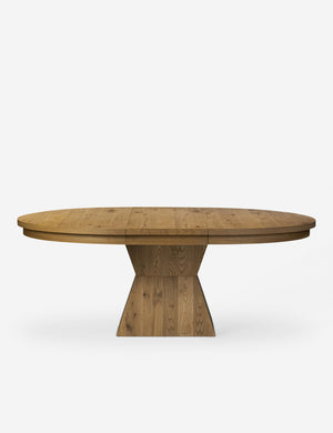Front on view of the Hermoza sculptural round pedestal extendable dining table.